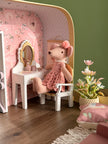 Ballerina mouse getting ready at the vanity table, with a potted flower and a swan poster on the wall