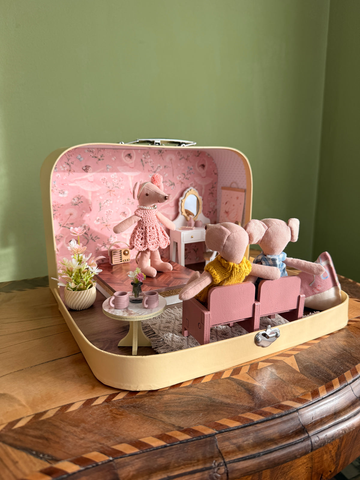 Ballerina suitcase dollhouse with an audience of mouse dolls watching the little ballerina from pink theatre seats