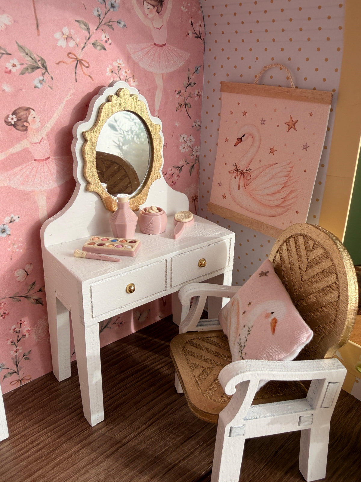Miniature white vanity table with gold mirror, tiny beauty accessories and a white chair in the ballerina dollhouse