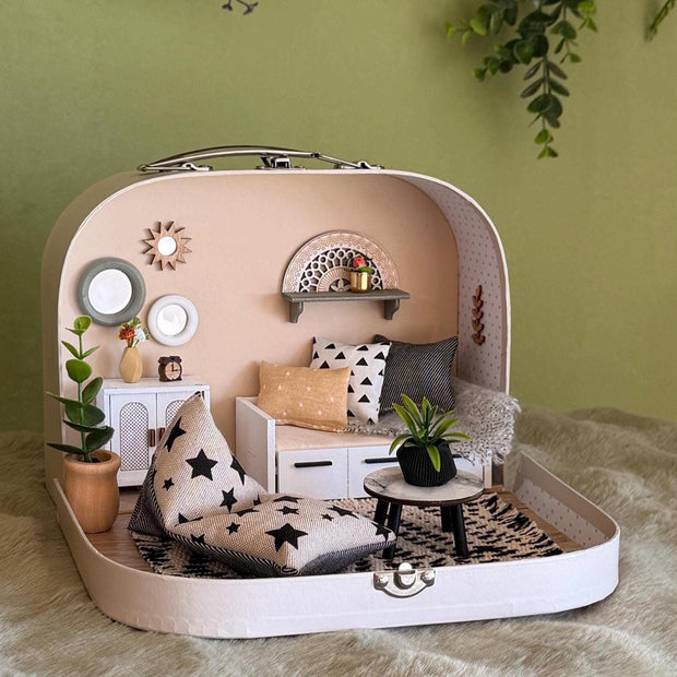 Scandinavian House small suitcase dollhouse with a white sofa bed, star floor cushion, round black table and boho wall decor