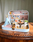 Happy Nest medium suitcase dollhouse with a play teepee, garland, round dining table and sleeping loft