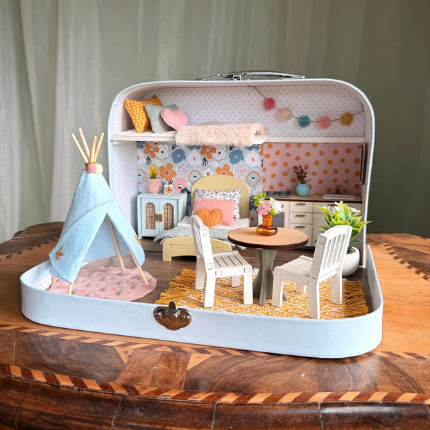 Happy Nest medium suitcase dollhouse with a play teepee, garland, round dining table and sleeping loft