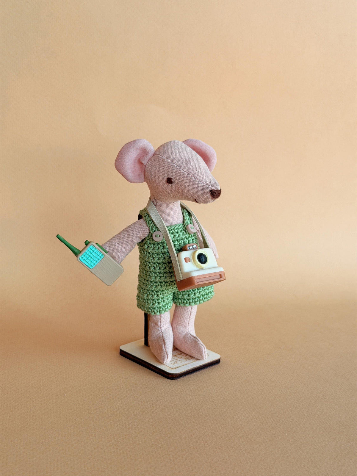 Pip, a handmade fabric mouse doll in green check overalls with a tiny camera and walkie-talkie