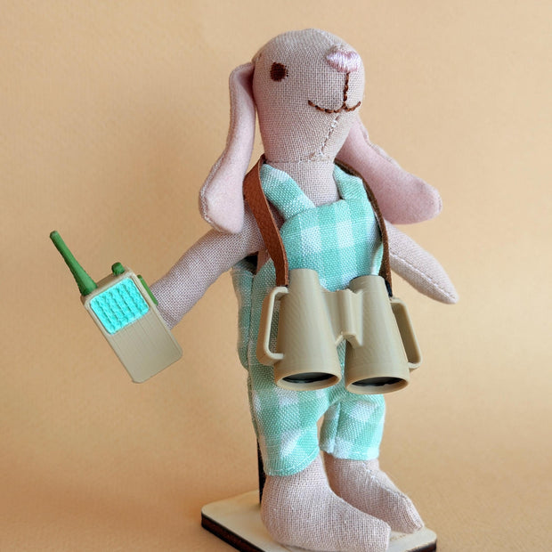Benjamin, a handmade fabric rabbit doll in mint overalls with tiny binoculars and a walkie-talkie