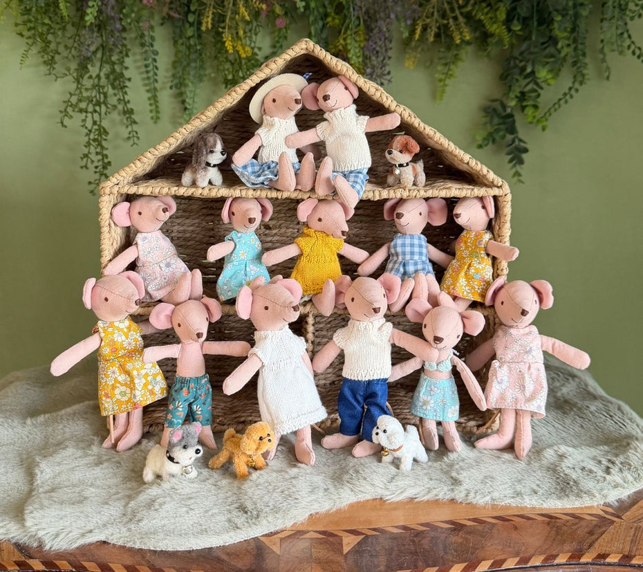 Handmade fabric mice in colourful outfits with tiny plush dogs in a woven dollhouse