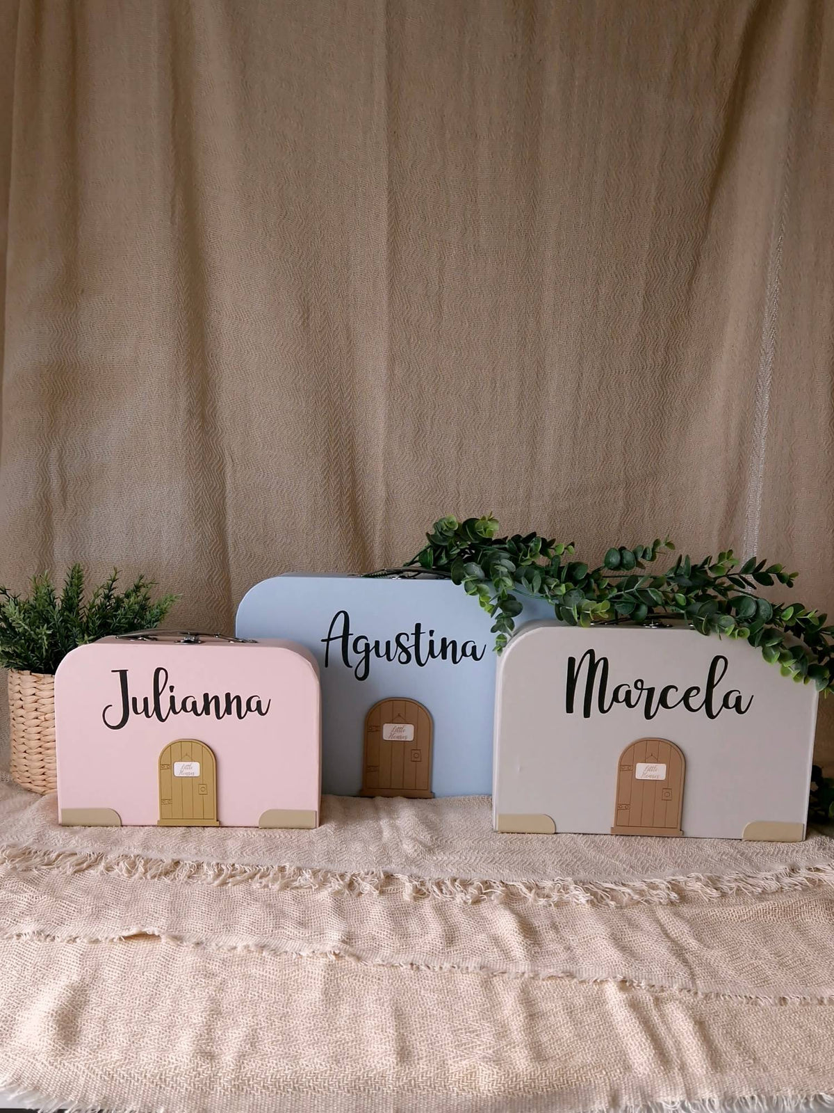 Closed suitcase dollhouses in three sizes with personalised names and a little door on the front